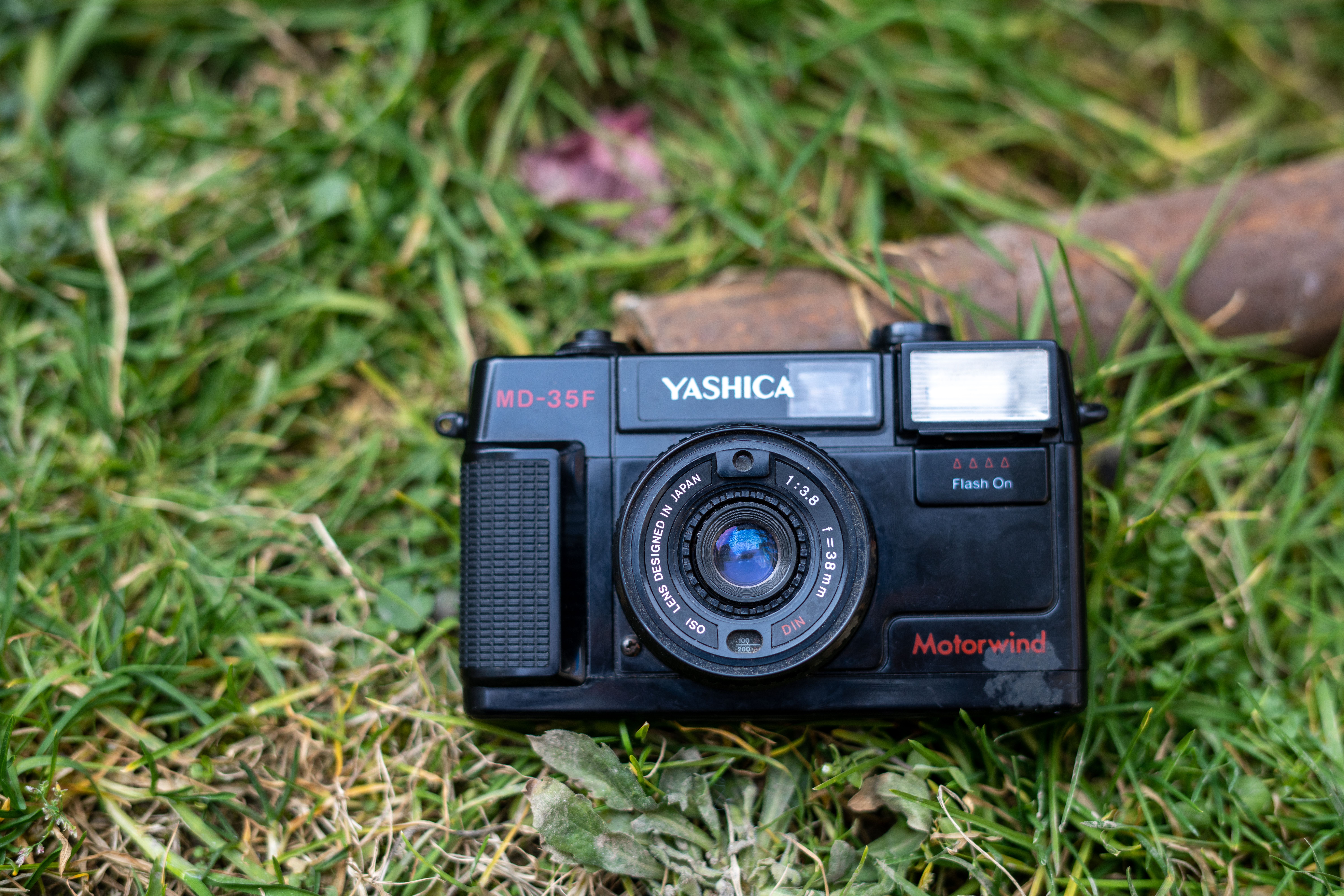 Close-up of a Yashica MD-35F camera on grass, showcasing vintage technology — ymag dividend history
