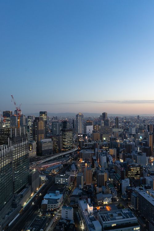 Free Discover the stunning aerial view of Osaka, Japan's skyline at twilight with its vibrant urban landscape. Stock Photo