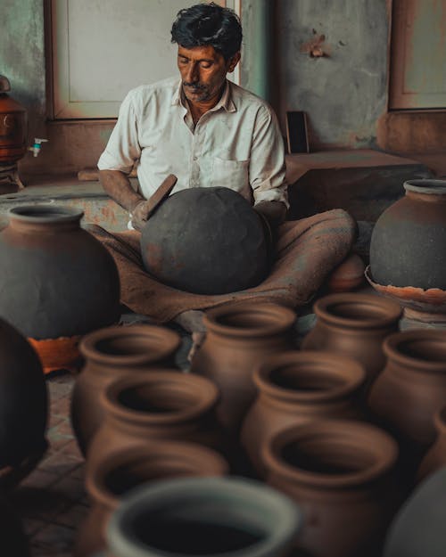 Man Sitting Making Ceramic Vase