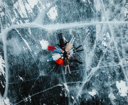 Aerial image of a group lying on cracked ice of a frozen lake in Baykalsk, Russia.