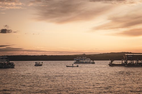 View of Passenger Boats on a Body of Water at Sunset