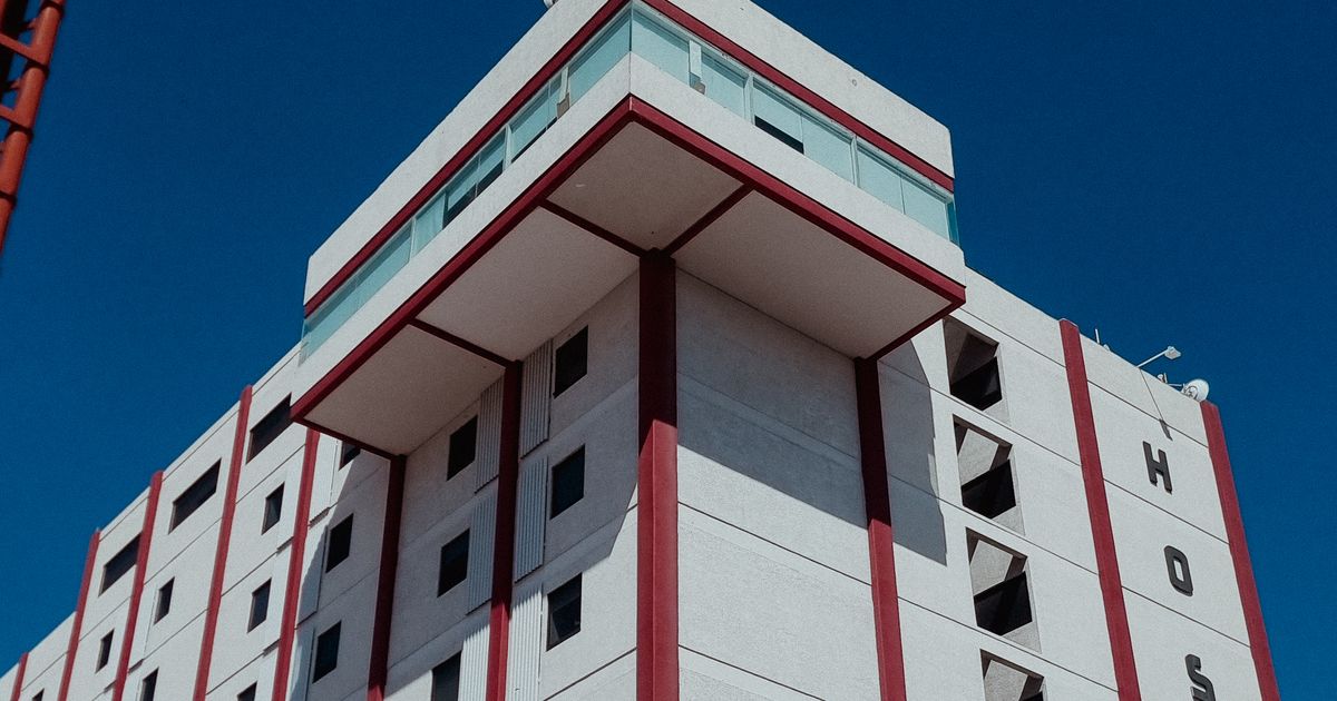 Modern hospital building against a clear blue sky