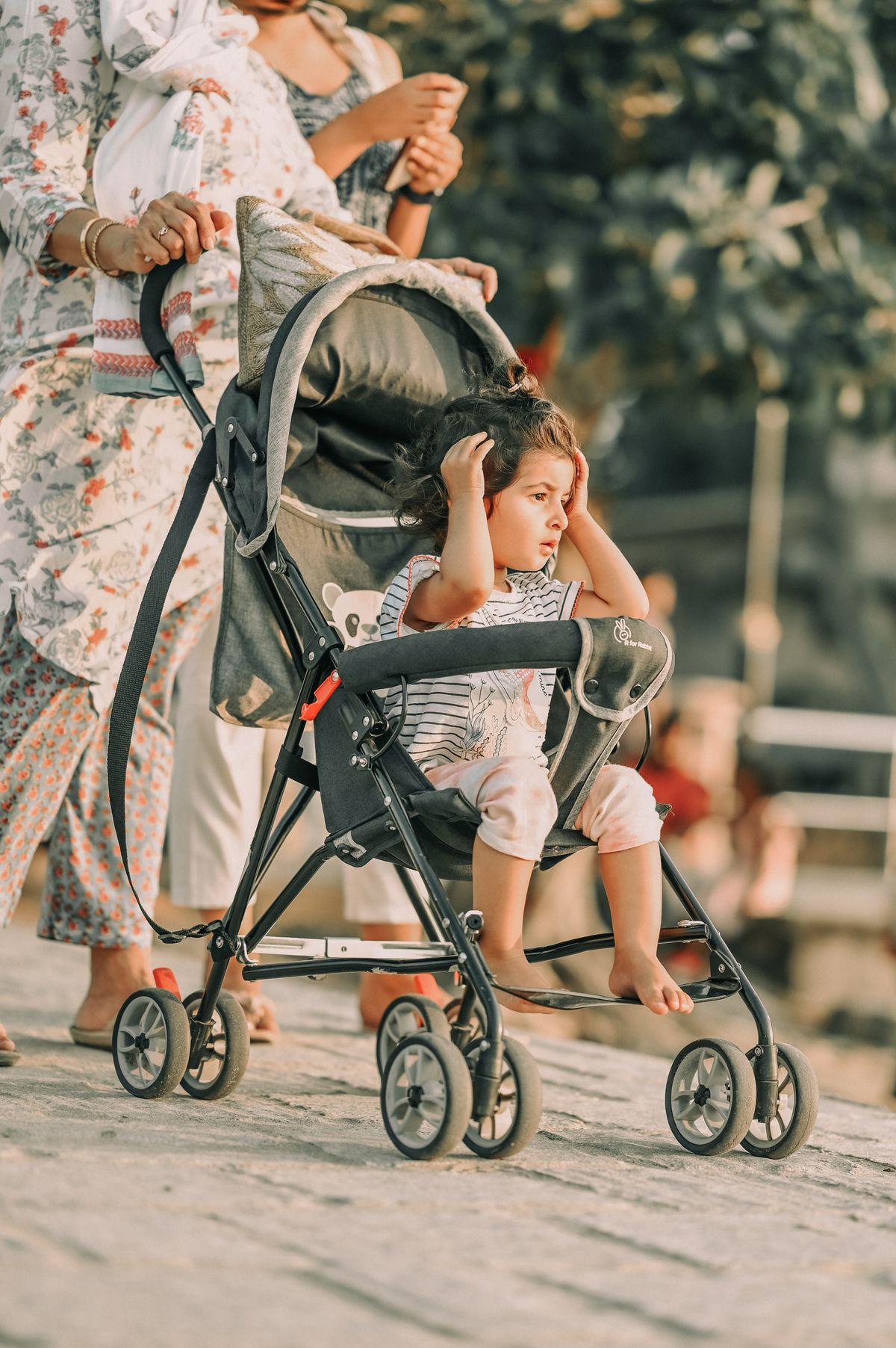 Mother pushing a baby stroller during a peaceful outdoor walk