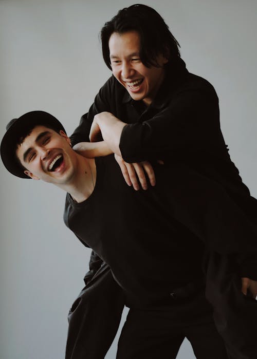 Portrait of Smiling Men in Black Clothes