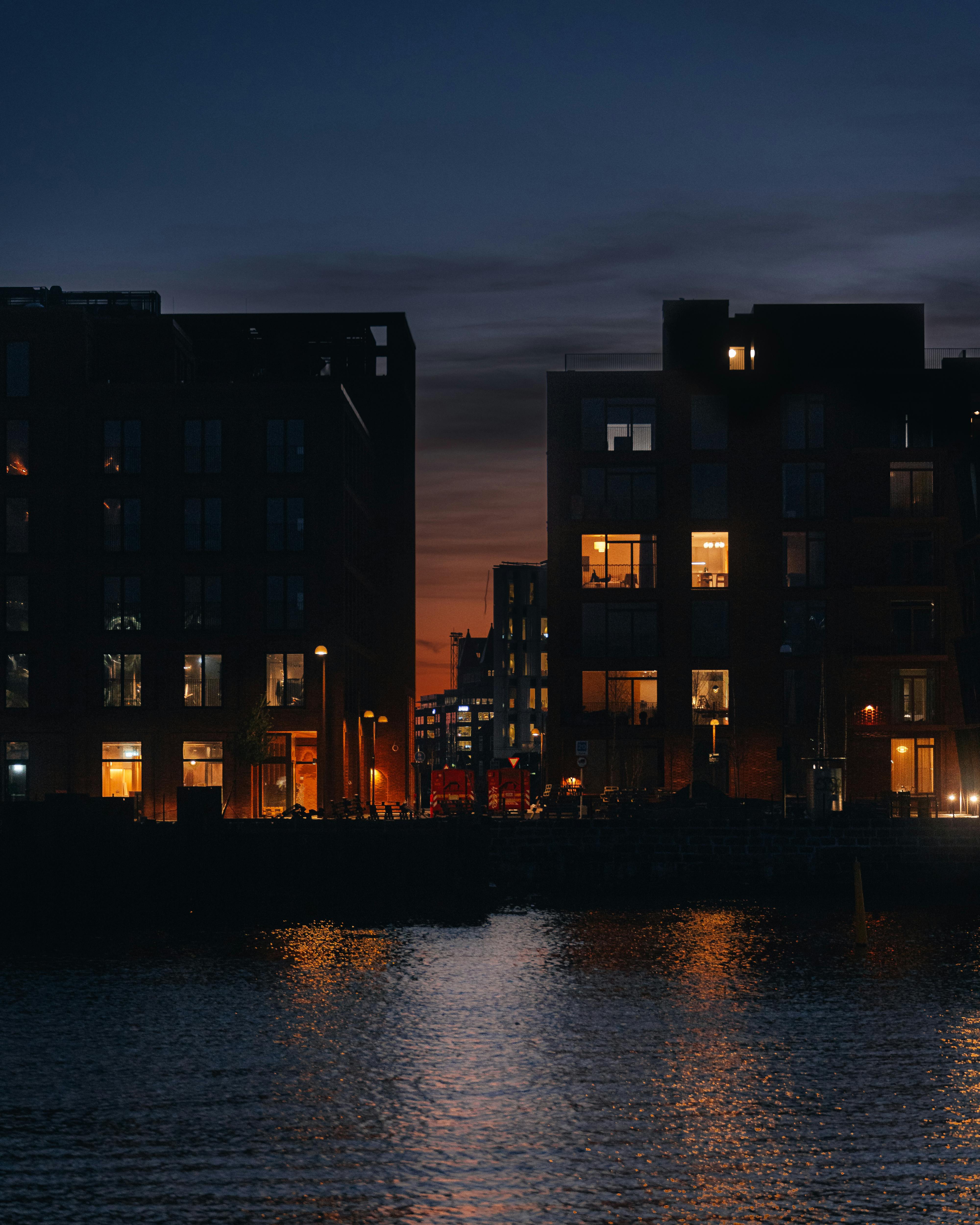 houses by river in town in evening