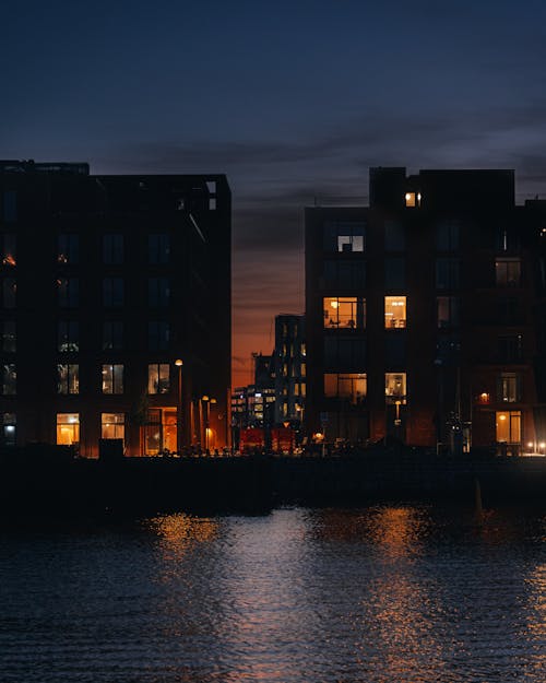 Houses by River in Town in Evening