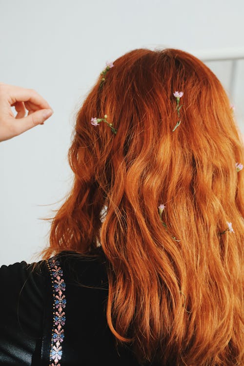 Back View of a Redhead Woman with Flowers in Her Hair