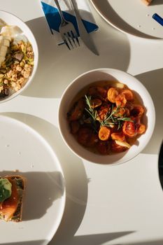 Close-up of a vibrant Mediterranean meal featuring roasted vegetables in natural light.