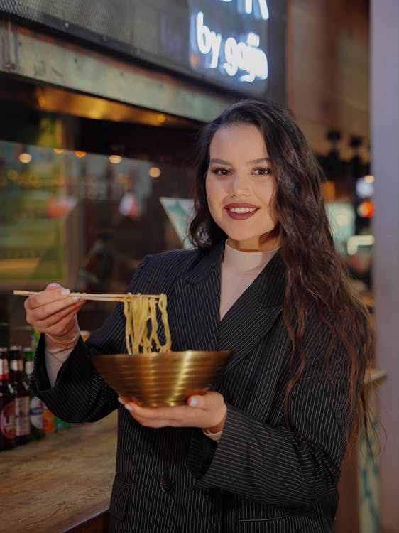 Woman Eating Pasta With Chopsticks Free Stock Photo woman-eating-pasta-with-chopsticks-free-stock-photo