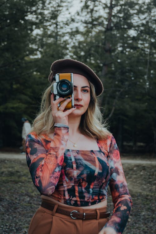Blonde Woman in Beret Standing with Camera