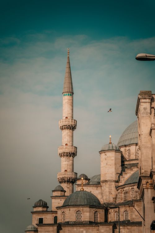 Free Vertical shot of a mosque minaret in Istanbul with clear blue skies, capturing architectural elegance. Stock Photo