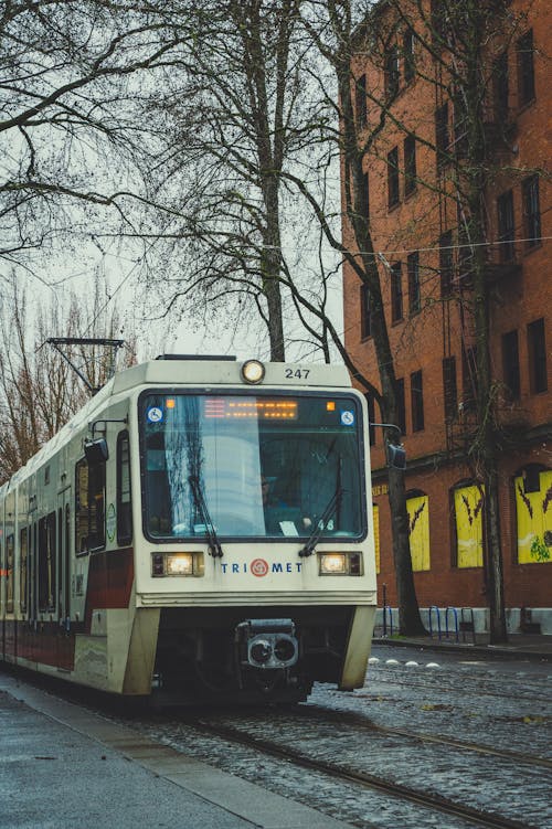 A train is traveling down the tracks on a rainy day