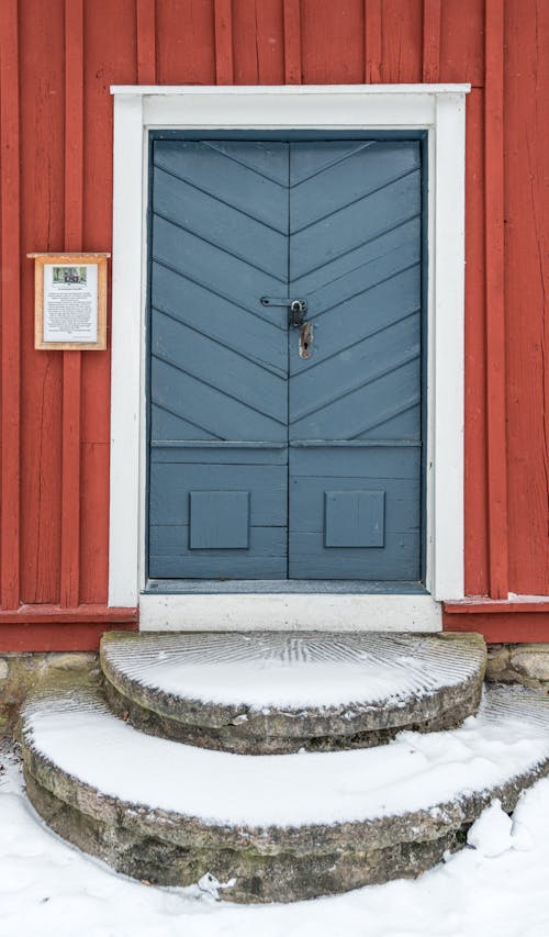 A blue door with steps leading up to it