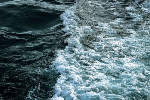 An invigorating scene of ocean waves and foam on a sunny day, showcasing nature's power.