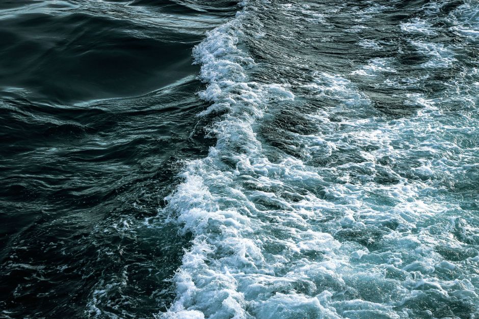 An invigorating scene of ocean waves and foam on a sunny day, showcasing nature's power.