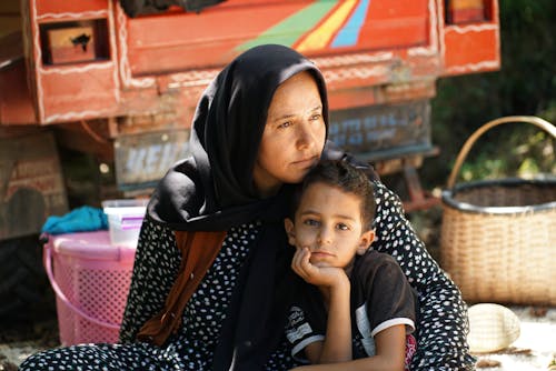 Free Mother in Hijab Hugging Boy Stock Photo