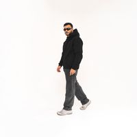 Oversized hooded fleece worn in a studio, front. Photo by Khalid Joe on Pexels
