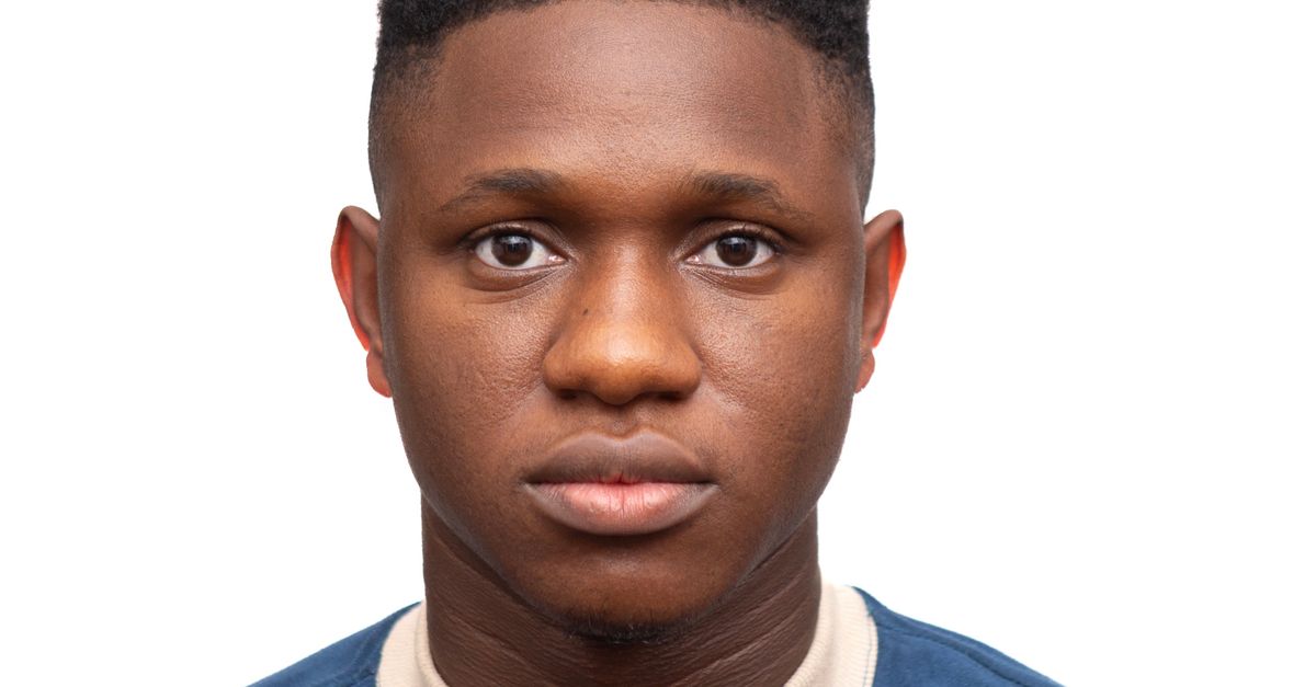 Close-up portrait of a serious young man with a neutral expression on a white background