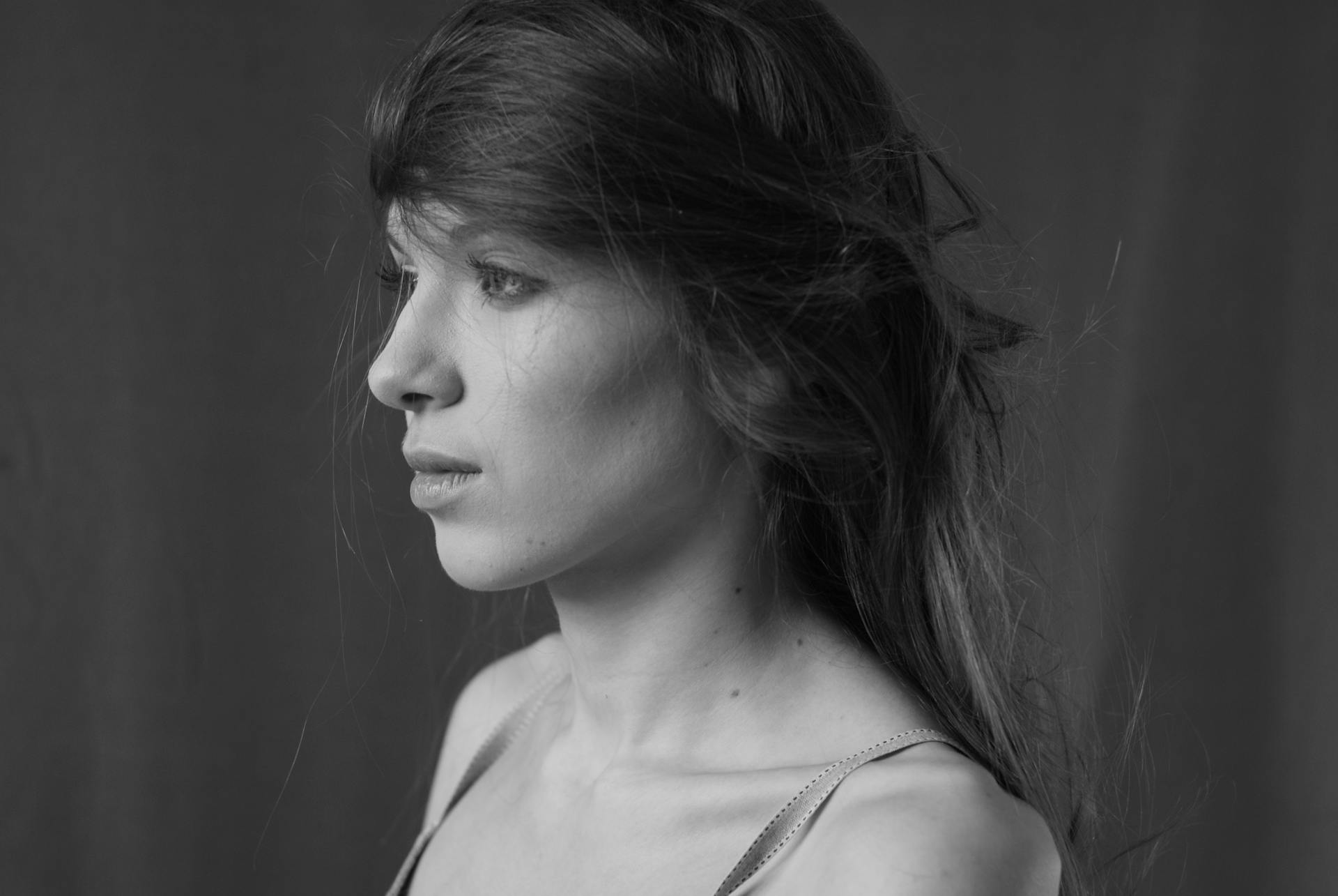 A woman with long hair in black and white