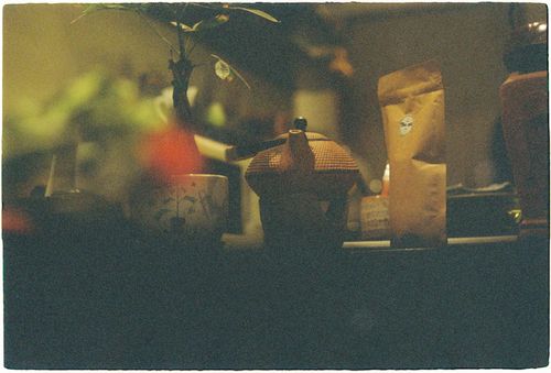 Free A dimly lit indoor scene featuring a teapot and coffee in a cozy atmosphere. Stock Photo