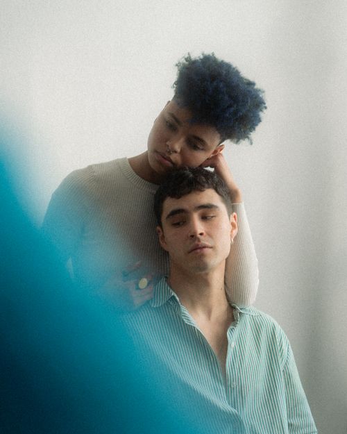 Free An intimate portrait of two people sharing a serene moment, highlighting diversity and connection. Stock Photo