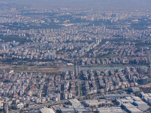 Free Aerial view of a sprawling urban area with dense buildings and a clear skyline. Stock Photo