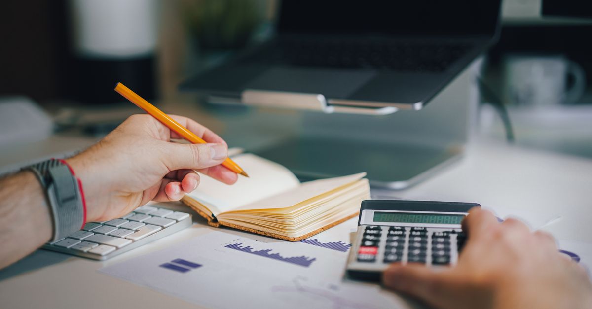 Federal finance report documents on a desk, showing Canada's deficit above $55 billion for the fiscal year