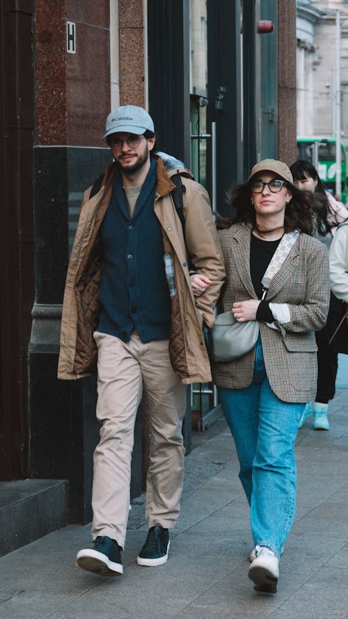 A man and woman walking down the street