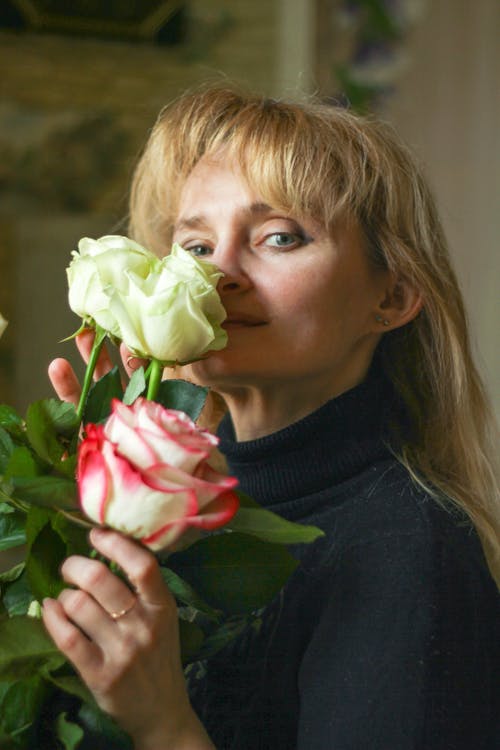 Woman Holding White and Pink Rose Flowers