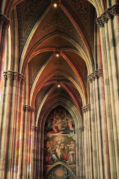 The interior of a cathedral with a large painting on the ceiling