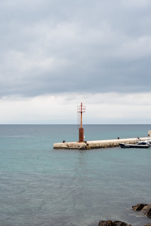 A boat is docked at a pier in the ocean