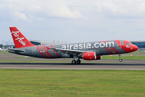 A red and white airplane on the runway