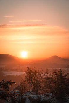 Breathtaking sunset view over a serene mountain landscape with a dramatic sky in Germany.