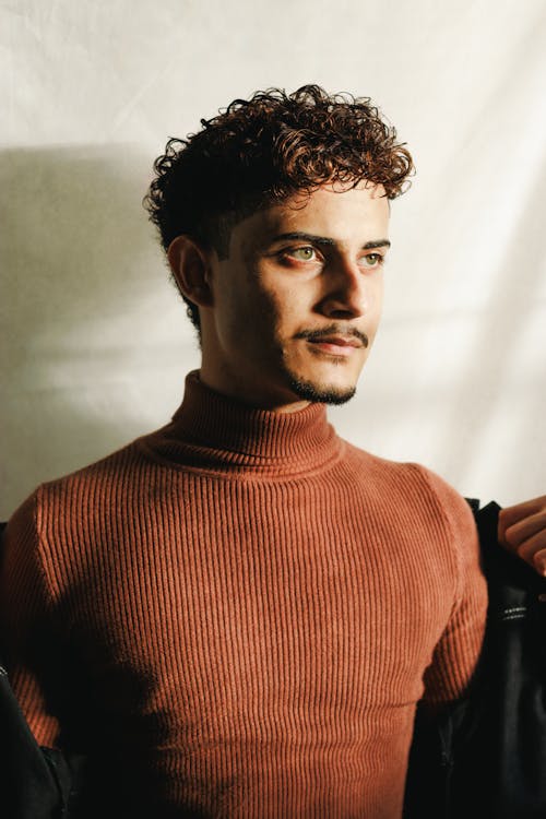 Curly Haired Man Wearing a Red Sweater