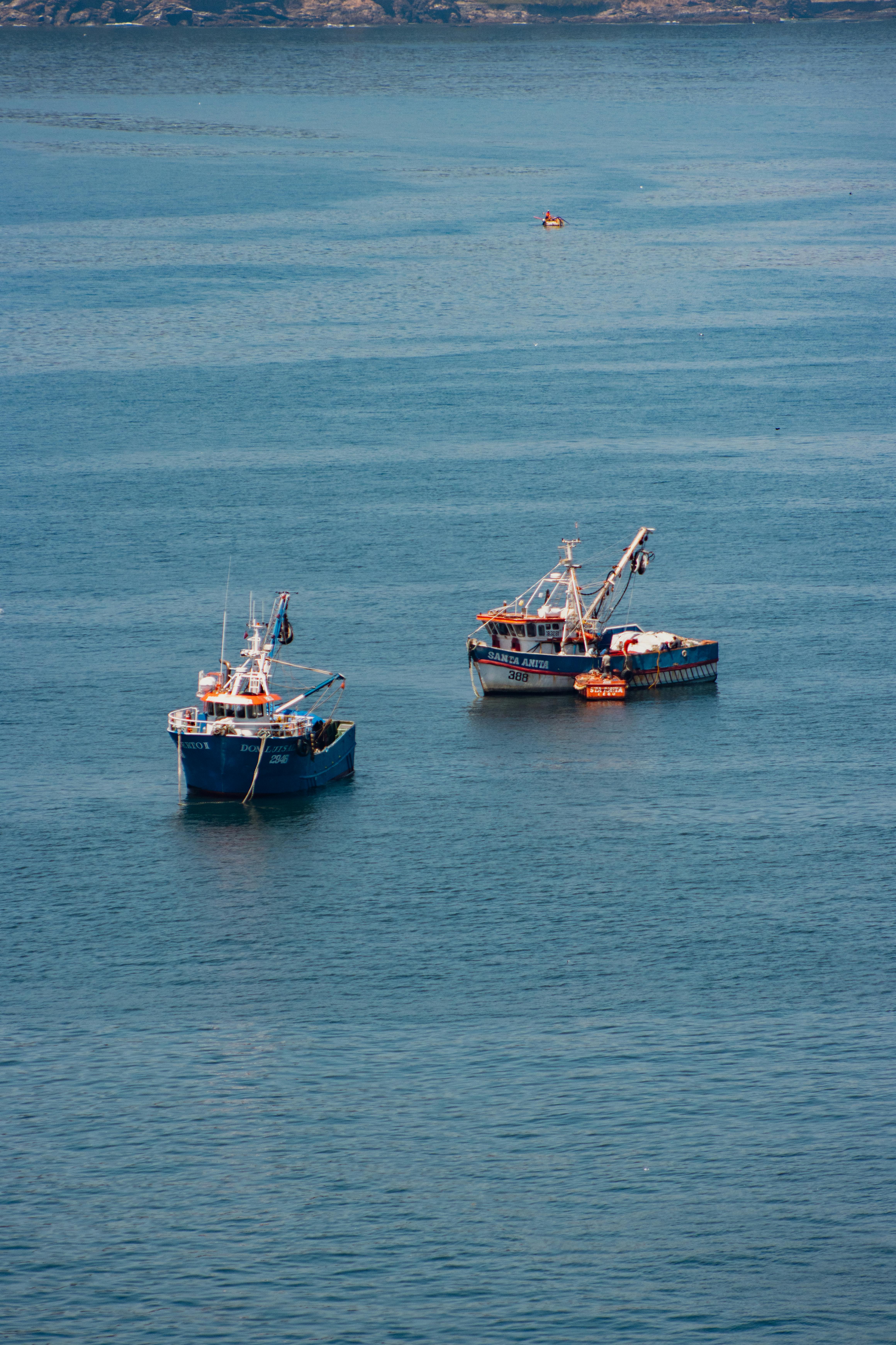 Fishing boats on the peaceful ocean off the coast of Lota, Bío Bío, Chile.