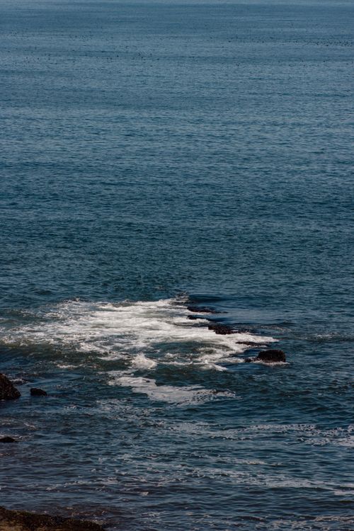 Free Tranquil scene of ocean waves splashing on rocks along Lota's beautiful coastline in Chile. Stock Photo