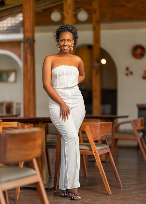 A woman in a white dress posing for the camera