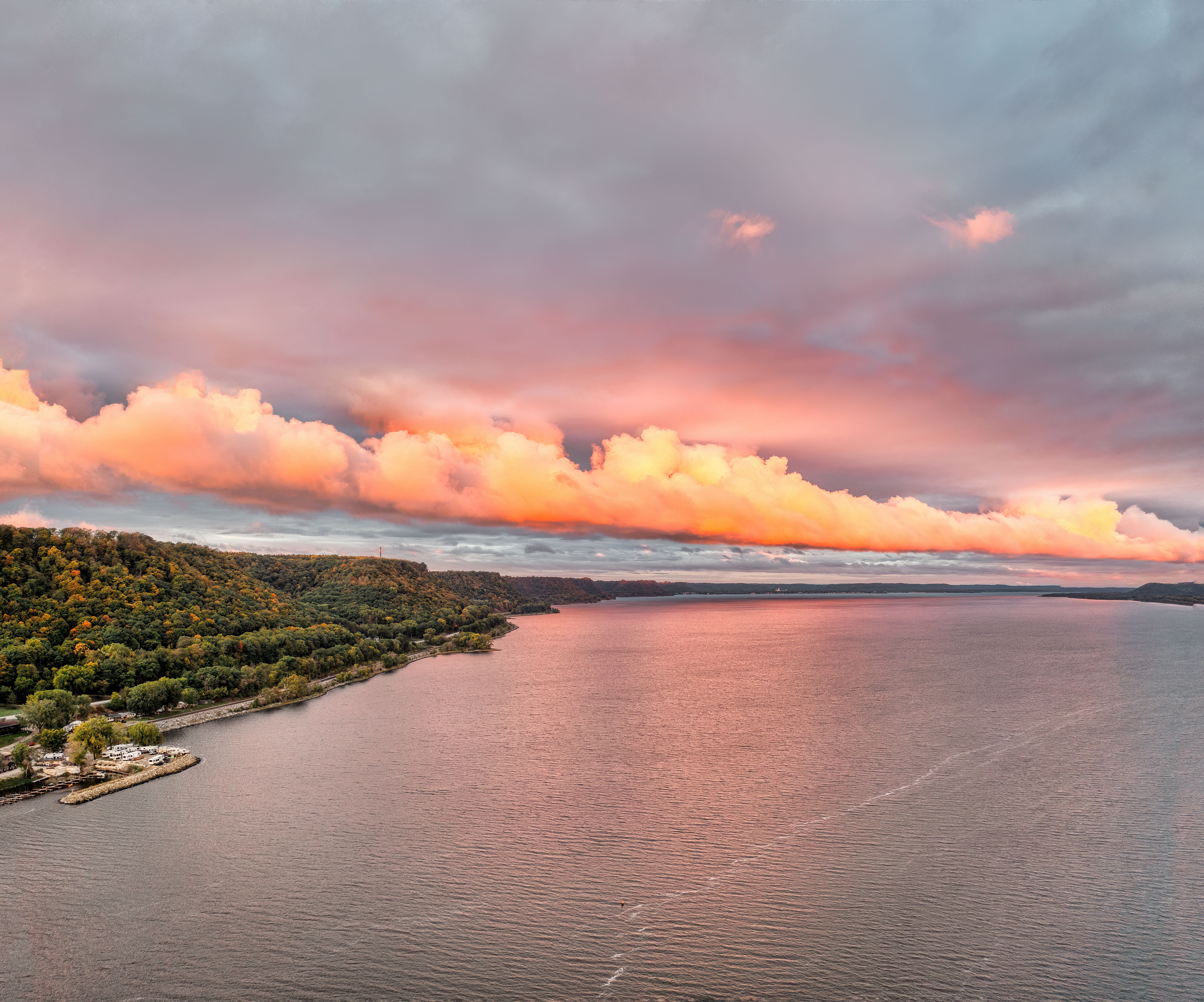 Breathtaking sunset over Reads Landing, MN showcasing vibrant clouds and scenic coastline.