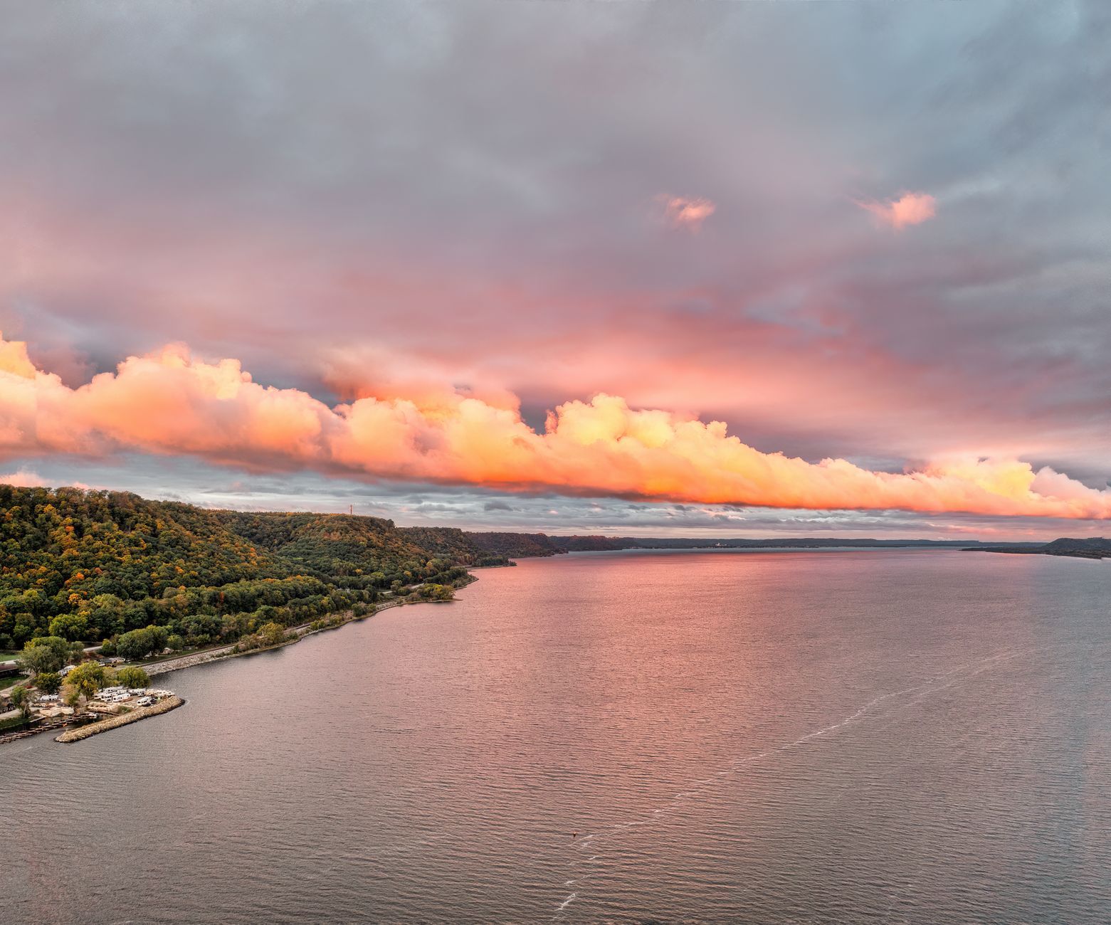 Breathtaking sunset over Reads Landing, MN showcasing vibrant clouds and scenic coastline.