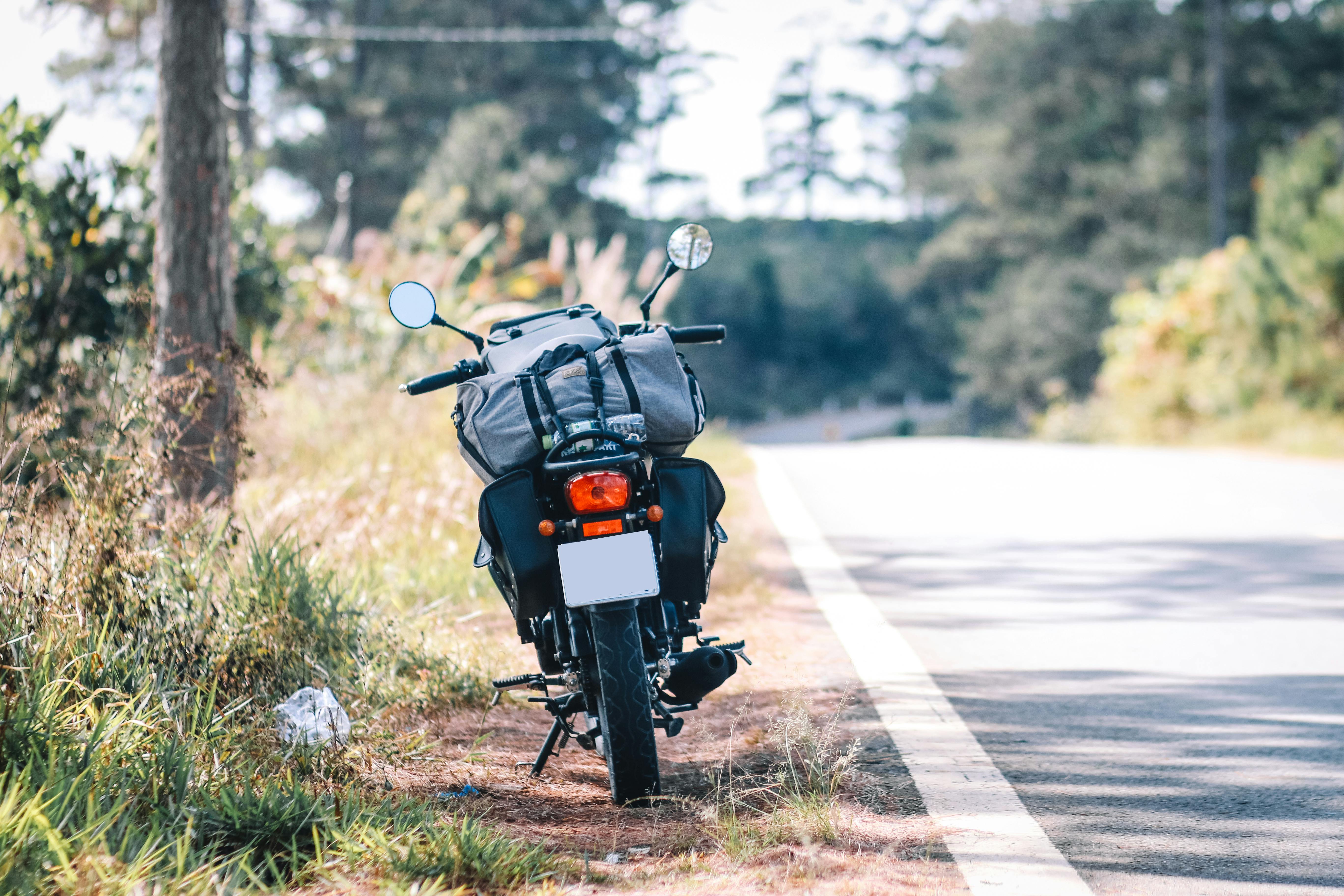 Motorbike parked by a scenic rural roadside, perfect for travel and exploration imagery.