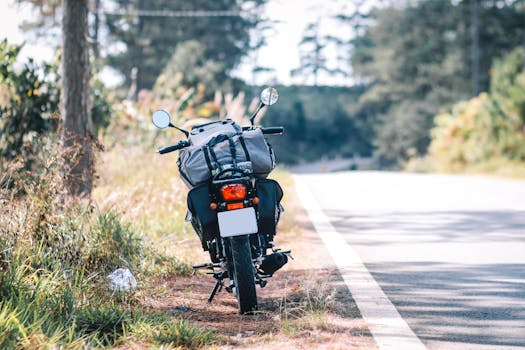 Motorbike parked by a scenic rural roadside, perfect for travel and exploration imagery.