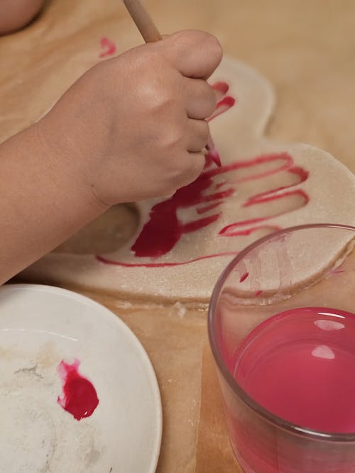 Hand of Child Painting with Pink Paint