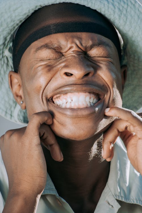 Man Smiling Widely and Shows his Teeth