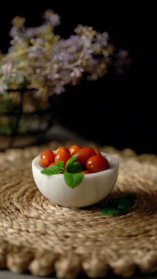Free Bowl of Grape Tomatoes and Basil Leaves Stock Photo