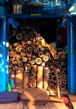 Rusty pipes stacked in a warehouse.
