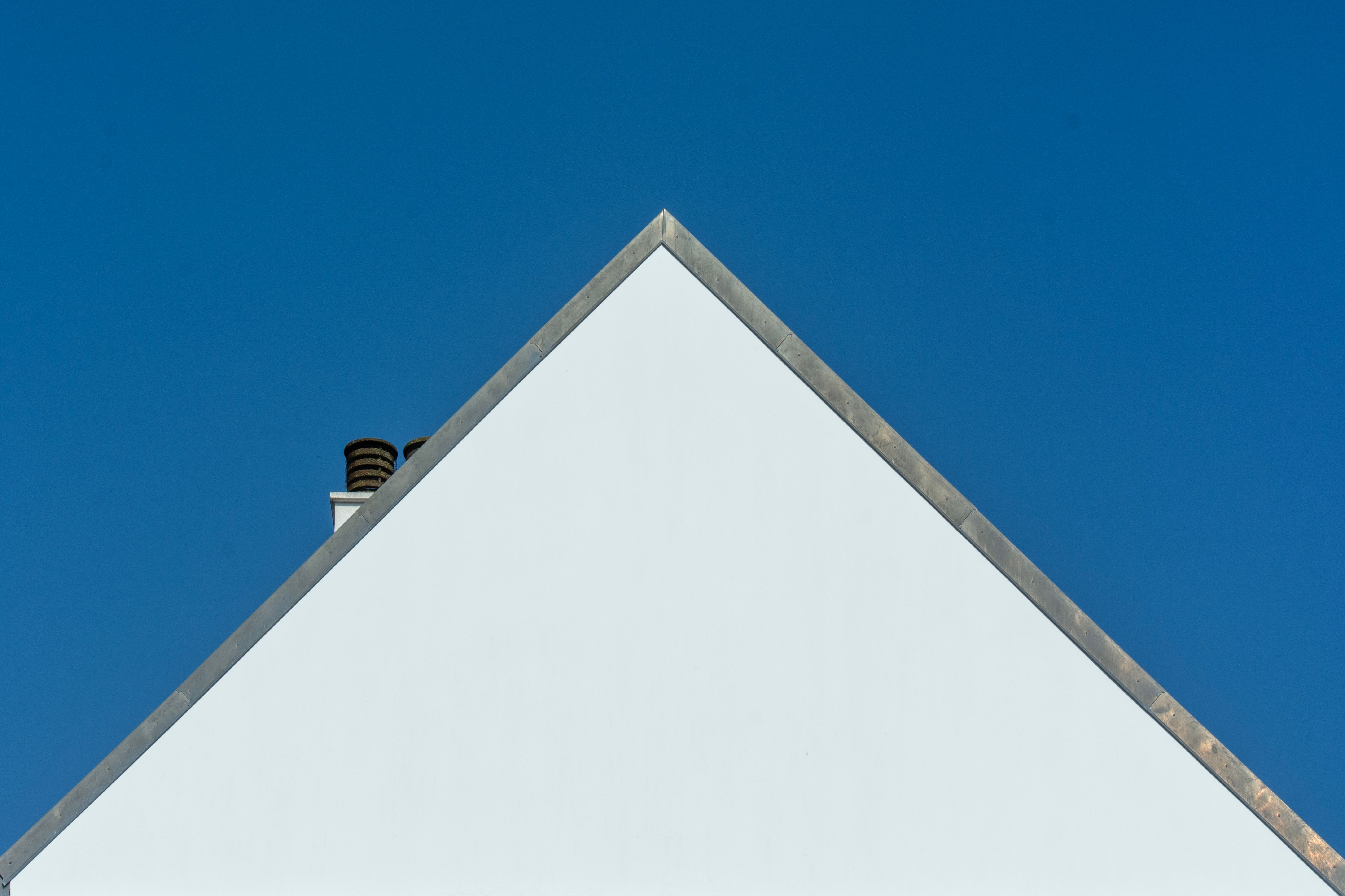 White Gable House Against Blue Sky · Free Stock Photo