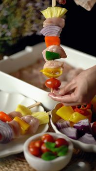 A person crafting delicious chicken and vegetable skewers, capturing a healthy culinary moment.