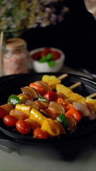 Tasty vegetable shashliks served on skewers featuring vibrant peppers and tomatoes.