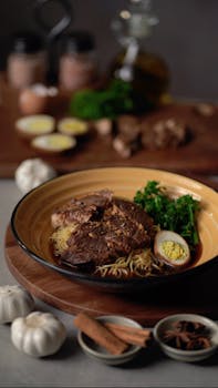 Delicious Thai roasted meat with noodles and vegetables on a plate, garnished with boiled egg.