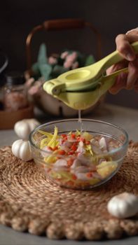 A vibrant salad is prepared with a lemon squeeze adding a fresh burst of flavor.